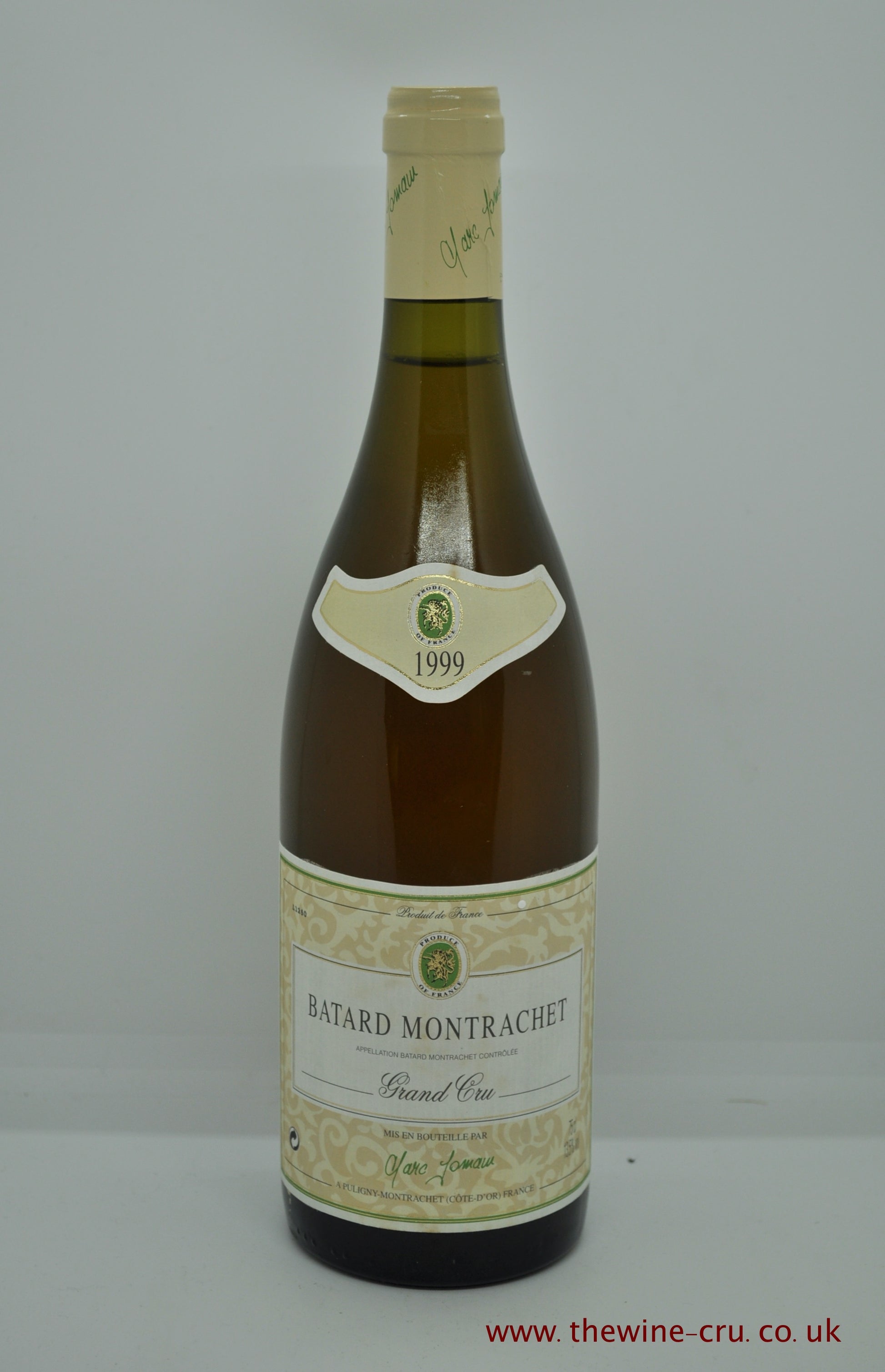 A bottle of 1999 vintage white wine. Batard Montrachet Domaine Jomain 1999. France Burgundy. Good capsule and label with the level of the wine below the capsule. The colour is a little dark as you would expect for a mature white Burgundy. Immediate delivery. Free local delivery. Gift wrapping available.