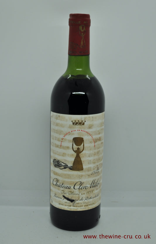 A bottle of 1975 vintage red wine. Chateau Clerc Milon Rothschild. Bordeaux, France. The label is glue striped and bin soiled. The wine level is top shoulder. Immediate delivery. Free local delivery. Gift wrapping available.