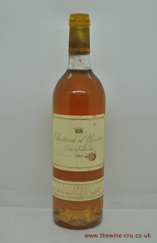 A bottle of 1985 vintage sweet white wine. Chateau d'Yquem Bordeaux, France. The  capsule is a little corroded and the label has a couple of staines. The wine level is base of neck. Immediate delivery. Free local delivery. Gift wrapping available.