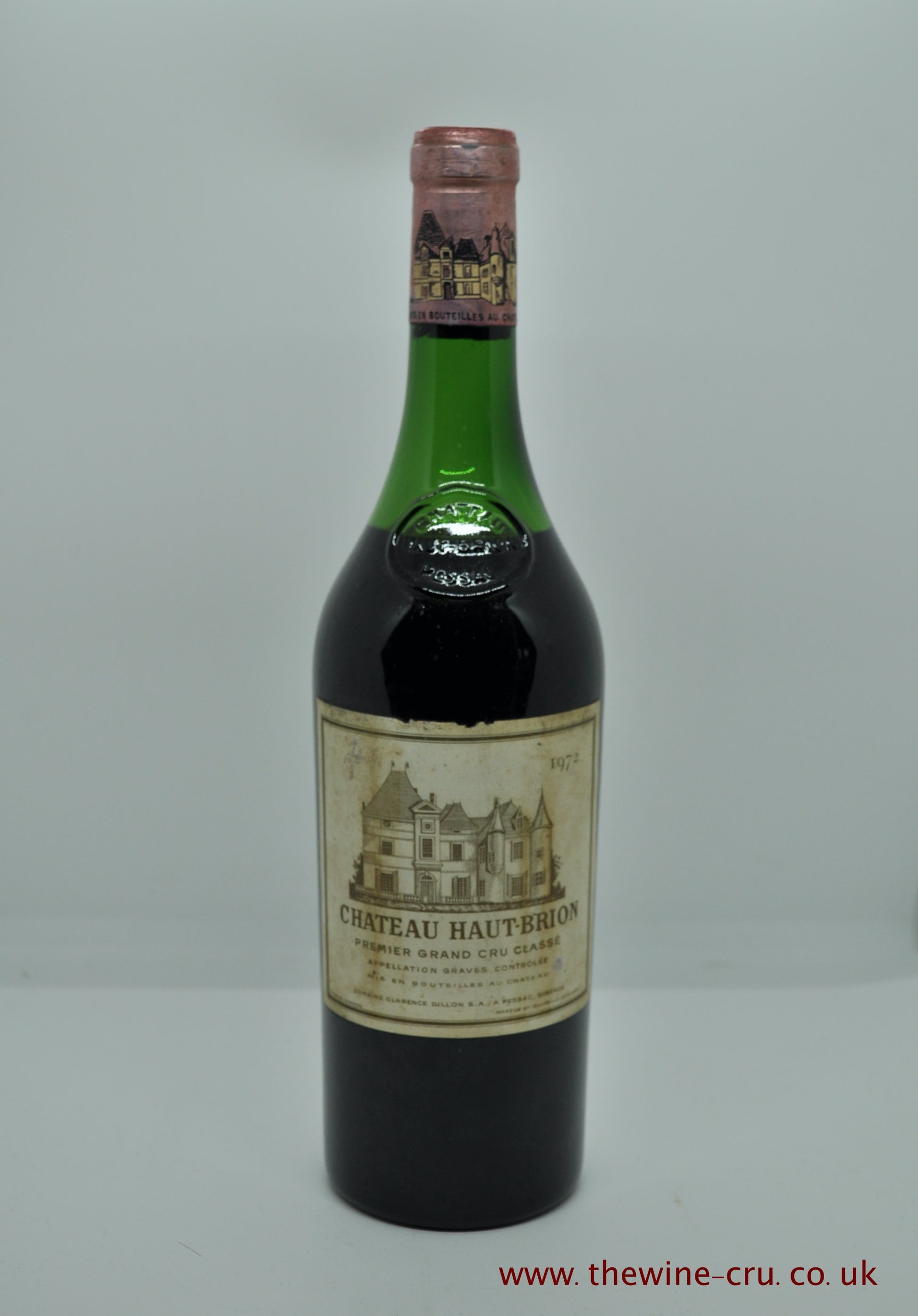 A bottle of 1972 vintage red wine. Chateau Haut Brion 1972. France, Bordeaux. The bottle is in good condition with the level being half way up the emblem. Immediate delivery. Free local delivery. Gift wrapping available.