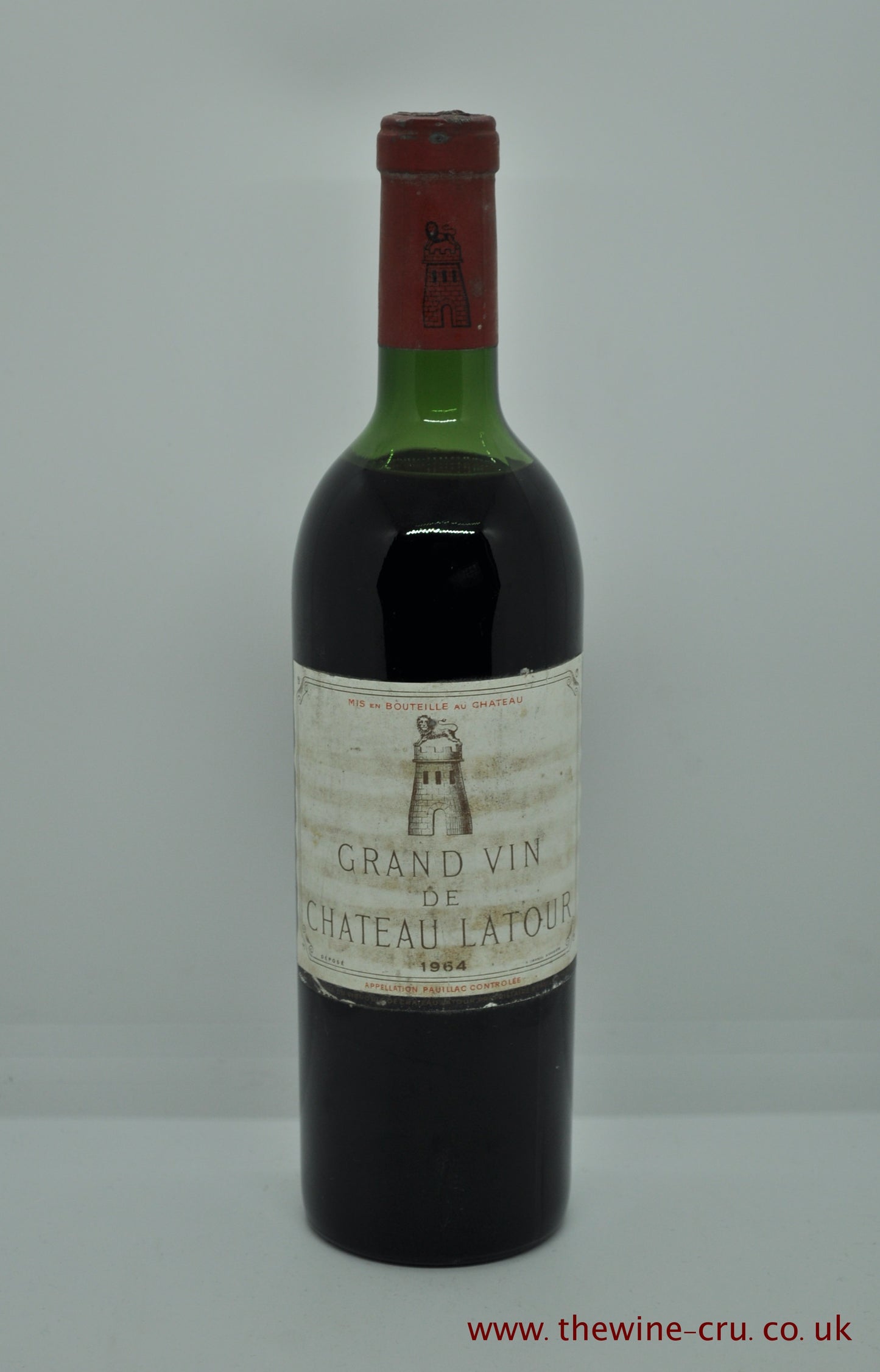 A bottle of 1964 vintage red wine. Chateau Latour, France, Bordeaux, Pauillac. Good capsule and label with the wine level top shoulder. Immediate delivery. Free local delivery. Gift wrapping available.