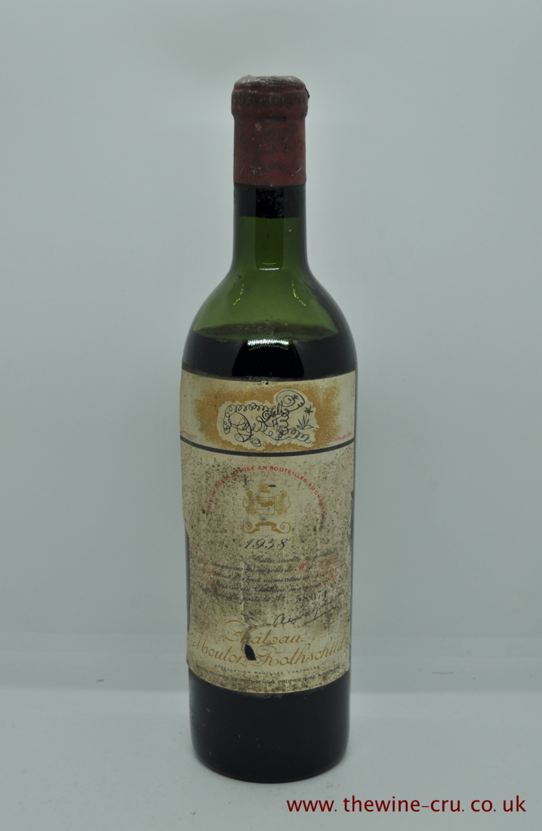 A bottle of 1958 vintage red wine. Chateau Mouton Rothschild. Bordeaux, France. The capsule has a little corrosion, the label complete but bins oiled. The wine level is low shoulder. Immediate delivery. Free local delivery. Gift wrapping available.