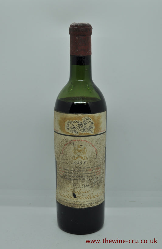 A bottle of 1958 vintage red wine. Chateau Mouton Rothschild. Bordeaux, France. The capsule has a little corrosion, the label complete but bins oiled. The wine level is low shoulder. Immediate delivery. Free local delivery. Gift wrapping available.