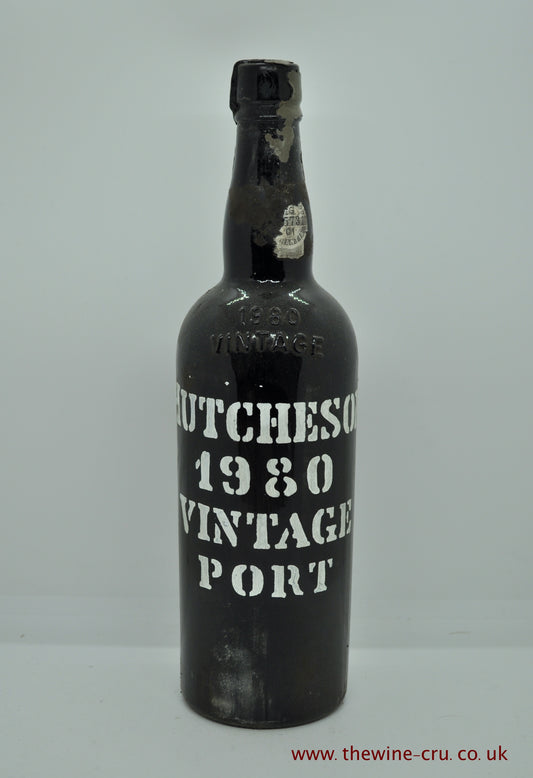 1980 vintage port wine. Hutcheson Vintage Port. The capsule is brittle, chipped with bits missing. The stencil is good. Wine level base of neck. Immediate delivery. Free local delivery. Gift wrapping available.
