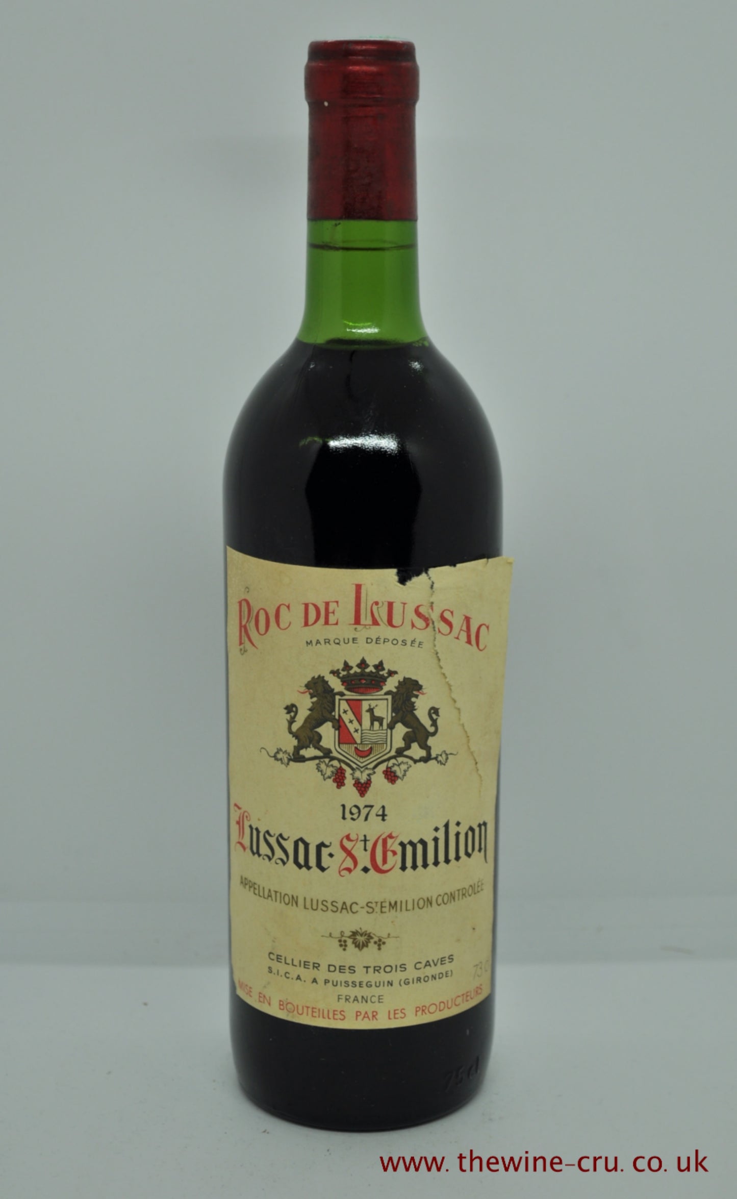A bottle of 1974 vintage red wine. Roc de Lussac Bordeaux, France. The bottle is in good condition. The label is torn and loose. The wine level being top shoulder. Immediate delivery. Free local delivery. Gift wrapping available.